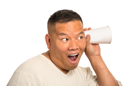 Headshot funny looking curious surprised middle aged man listening to conversation isolated white  background. Face expression, reaction, emotion. Privacy violation conceptの写真素材