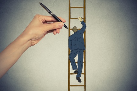 Young business man climbing up career ladderの写真素材