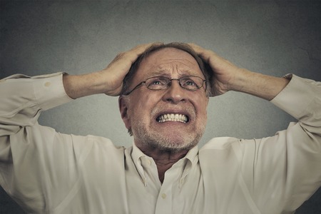 Closeup portrait headshot furious frustrated elderly man having bad hard day screaming looking up isolated on gray wall background. Negative face expression emotionの写真素材