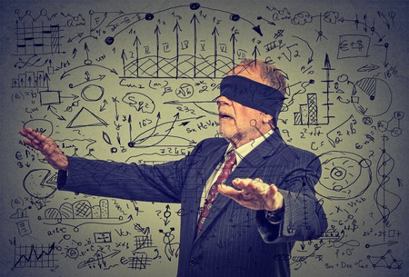 Portrait blindfolded elderly senior business man going through social media dataの写真素材