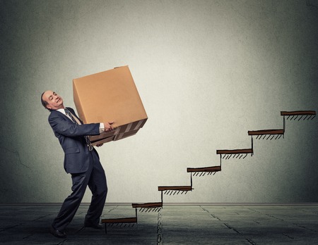 Middle aged business man with a difficult taskの写真素材