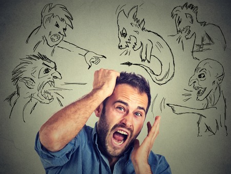 Evil men pointing at stressed anxious guy. Portrait desperate young businessman frustrated screaming...
