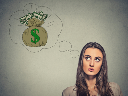 Woman dreaming of financial success a lot of moneyの写真素材