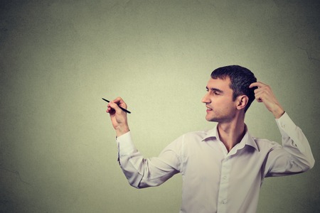 Portrait young creative man drawing, template for illustration on gray wall backgroundの写真素材