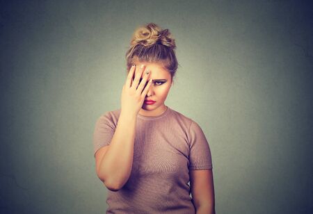 Closeup portrait sad young beautiful woman with worried stressed face expression looking down
