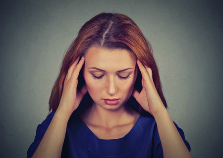 Closeup portrait sad young beautiful woman with worried stressed face expression looking downの写真素材