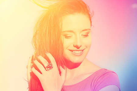 Portrait of a beautiful sunshine girl. Closeup happy smiling woman. Sunny summer day under hot sun...