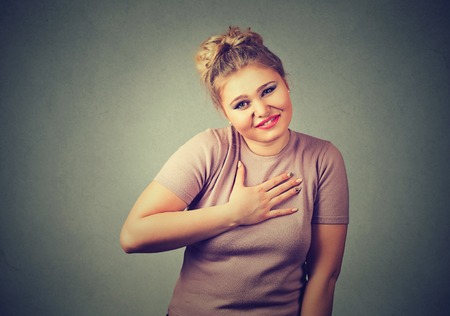 young woman gesturing with hand, please forgive me pretty please with isolated gray background....