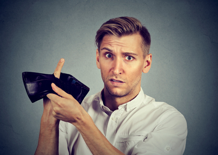 Man with no money. Businessman holding empty wallet