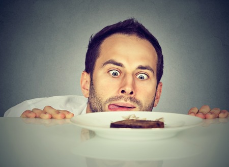 Hungry man craving sweet foodの写真素材