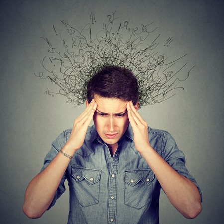 Closeup sad young man with worried stressed face expression and brain melting into lines question...