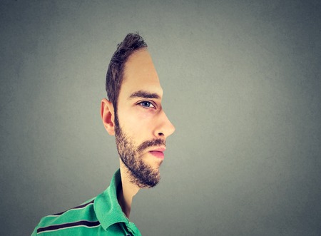 surrealistic portrait front with cut out profile of a young man isolated on grey wall backgroundの写真素材