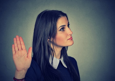 Closeup portrait young annoyed angry woman with bad attitude giving talk to hand gesture with palm outward isolated grey wall background. Negative human emotion face expression feeling body languageの写真素材