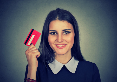 woman shopping on line holding showing credit cardの写真素材