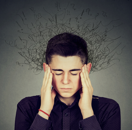 Sad young man with worried stressed face expression and brain melting into lines question marks....