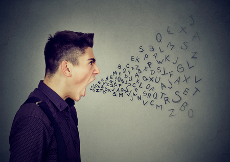Angry man screaming with alphabet letters coming out of open mouth 