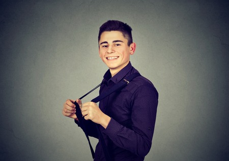 Portrait of funny handsome man pulling his suspendersの写真素材