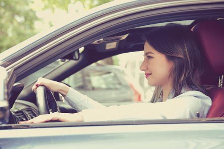 young happy woman driving a carの写真素材