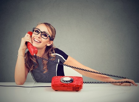 Happy funny looking woman calling someoneの写真素材