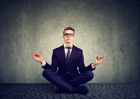 Business man meditating relaxing with eyes closed の写真素材