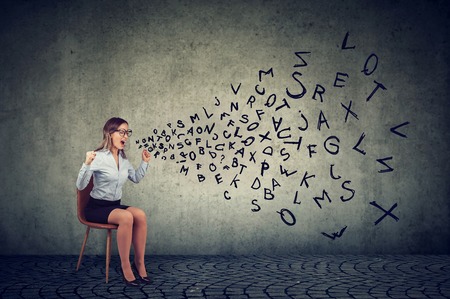 Stressed frustrated isolated female employee sitting on a chair screaming in frustration の写真素材