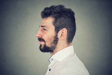 Side view portrait of a young smiling bearded manの写真素材
