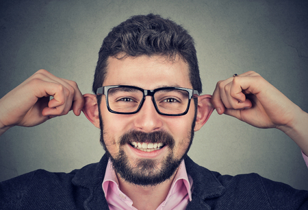 Funny young man making silly facesの写真素材