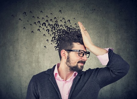 Man with worried stressed face expression and many questions