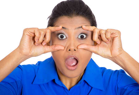 Closeup of a shocked looking young woman isolated on white background の写真素材