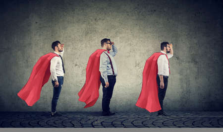 Team of super men looking into the future feeling brave and confident