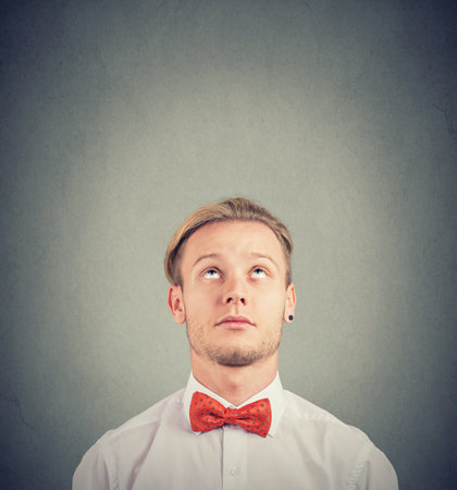 Portrait of a young man thinking looking upの写真素材