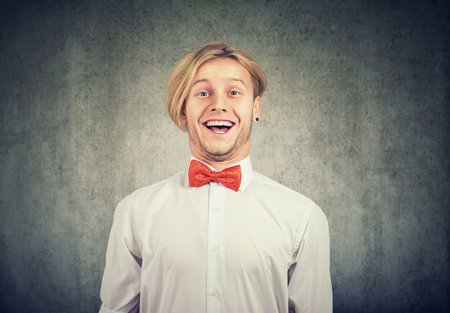 Portrait of a young man with happy surprise facial expressionの写真素材