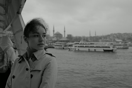 Happy young woman enjoying the sea from ferry boat crossing Bosphorus in Istanbul.の写真素材