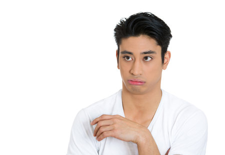 Portrait of an annoyed displeased difficult young manの写真素材