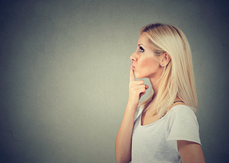 portrait of a thinking looking up womanの写真素材