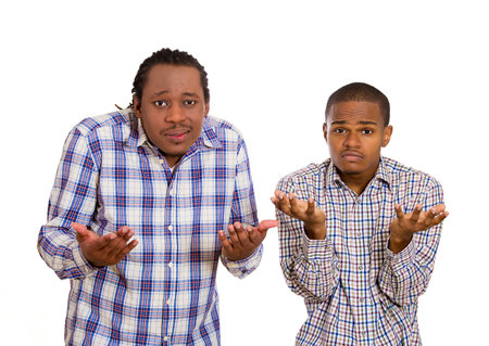 Closeup portrait of two angry, unhappy, young men arms out asking what's problem, who cares, so what, I don't know. Isolated on white backgroundの写真素材