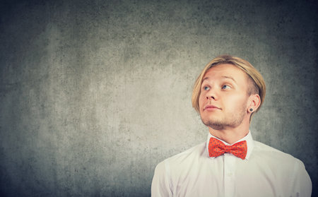 Portrait of a stylish man looking up and to the sideの写真素材