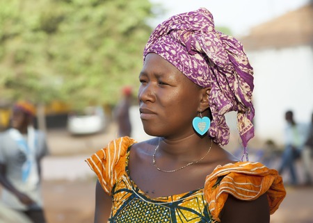 Gabu, Guinea-Bissau - March 28, 2014: Portrait of an unidentified african woman from fulani people wearing traditional clothes and scarfのeditorial素材