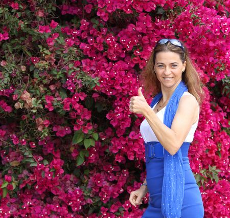 beautiful woman laughing and giving the thumbs-upの写真素材