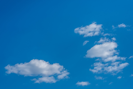 Bright blue sky with cloudsの写真素材