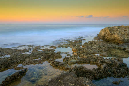 Sunset over the cliffs of Bahar ic-Caghaq in Malta の写真素材