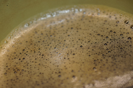 Macro close-up shot of nice coffee foam on the surface of a strong black coffee cupの写真素材