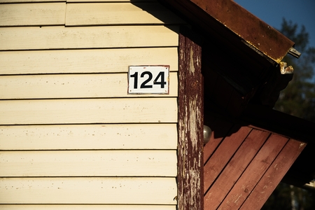 A number of houses on a large territory, in the suburbs.House with plastic boards and a roof made of corrugated sheetの写真素材