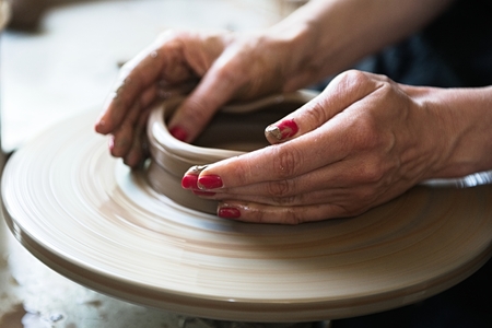 A lace maker and ceramicist create artwork. Hands top viewの写真素材
