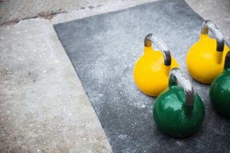 used kettlebell outside on the floor ready for strength and conditioning workout and training