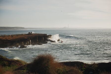 beautiful African rugged coastline with waves crashing against the cliffs
