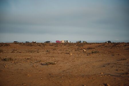 fishermen camping tents and cars on scenic west coast of the West Sahara, Morocco, Africaの写真素材