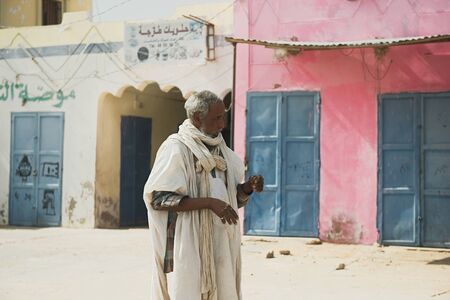 FERLO DESERT, SENEGAL, JANUARY 17, 2020: Unidentified Fulani man walks along the street. Fulanis are the largest tribe in West African savannahsのeditorial素材