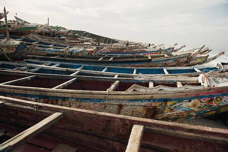 KAYAR, SENEGAL - JANUARY 17, 2020: Traditional painted wooden fishing boat in Kayar, Senegal. West Africa.のeditorial素材