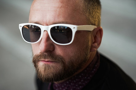 Bearded man portrait. Guy bearded in sunglasses. Close up of handsome bearded man sunglassesの写真素材